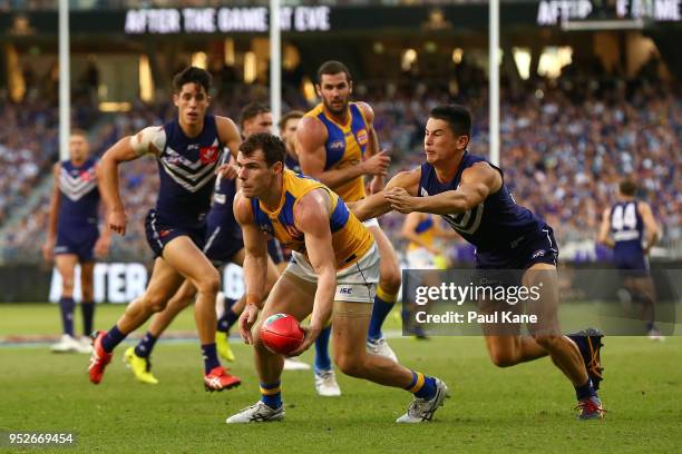 Luke Shuey of the Eagleslooks to handball against Bailey Banfield of the Dockers during the Round 6 AFL match between the Fremantle Dockers and West...