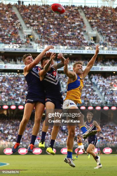 Luke Ryan and Nathan Wilson of the Dockers contest a mark against Mark LeCras of the Eagles during the Round 6 AFL match between the Fremantle...