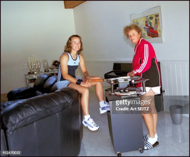 Martina Hingis and her mother restring a tennis racket in their living room. The hi-tech stringing machine has wheels to be portable. Standard...