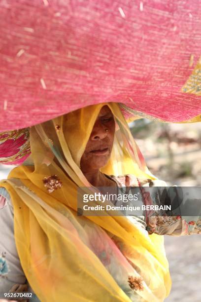 Femme portant un sac de paille Radjasthan Inde.