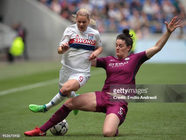 Eugenie Le Sommer of Olympique Lyonnais competes for the ball with Jennifer Beattie of Manchester City Women during the UEFA Women's Champions...