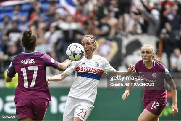 Lyon's French midfielder Camille Abily vies with Manchester City's British forward Nikita Parris and Manchester City's British forward Georgia...