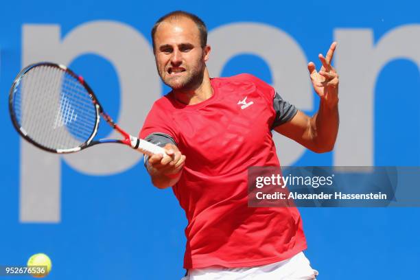 Marius Copil of Rumania plays a fore hand during his qualification match against Andrej Martin of Slovakia on day 2 of the BMW Open at MTTC IPHITOS...