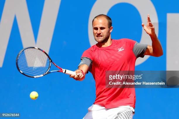 Marius Copil of Rumania plays a fore hand during his qualification match against Andrej Martin of Slovakia on day 2 of the BMW Open at MTTC IPHITOS...