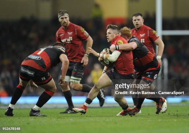 Scarlets' Steff Evans is tackled by Dragons' Dan Suter during the Guinness PRO14 Round 21 Judgement Day VI match between Cardiff Blues and Ospreys at...