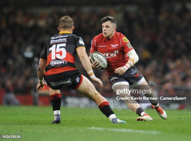 Scarlets' Steff Evans under pressure from Dragons' Hallam Amos during the Guinness PRO14 Round 21 Judgement Day VI match between Cardiff Blues and...