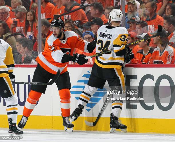 Brandon Manning of the Philadelphia Flyers backchecks Tom Kuhnhackl of the Pittsburgh Penguins into the glass in Game Six of the Eastern Conference...