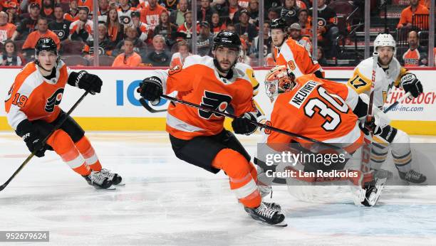Nolan Patrick, Shayne Gostisbehere, Michal Neuvirth and Robert Hagg of the Philadelphia Flyers react to the play along the far boards against Bryan...