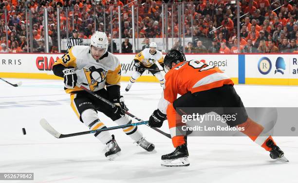 Ivan Provorov of the Philadelphia Flyers shoots the puck behind Conor Sheary of the Pittsburgh Penguins in Game Six of the Eastern Conference First...