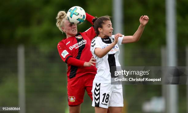 Merle Barth of Leverkusen and Naemi Hausen of Freiburg II go up for a header during the Second Frauen-Bundesliga Suedstaffel match between Bayer...