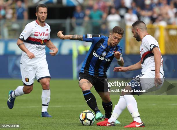 Alejandro Dario Gomez of Atalanta BC is challenged by Davide Biraschi of Genoa CFC during the serie A match between Atalanta BC and Genoa CFC at...