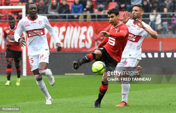 Rennes' midfielder Benjamin Andre vies with Toulouse's forward Andy Delort and Toulouse's defender Giannelli Imbula during the French L1 football...