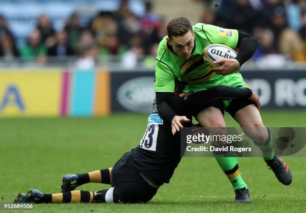 George North of Northampton Saints is tackled by Juan De Jongh of Wasps during the Aviva Premiership match between Wasps and Northampton Saints at...