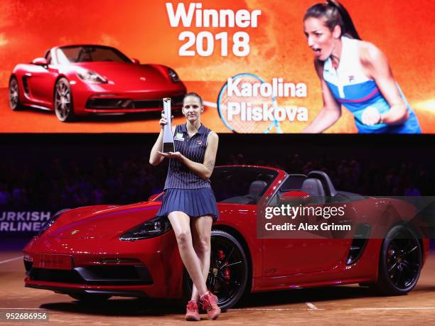 Karolina Pliskova of Czech Republic celebrates with the trophy and the winner's car Porsche 718 Boxster GTS after winning the singles final match...