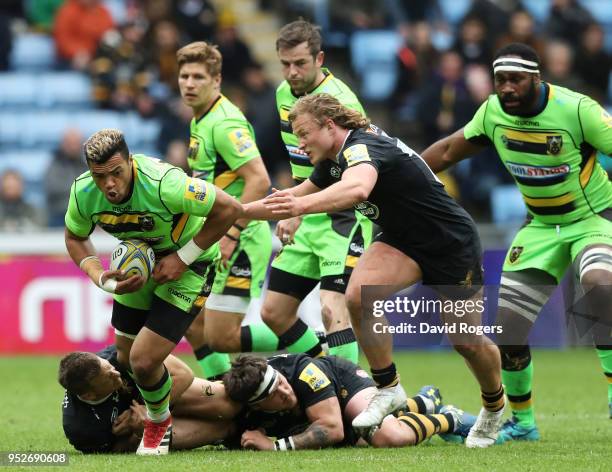 Luther Burrell of Northampton Saints is tackled by Tommy Taylor of Wasps during the Aviva Premiership match between Wasps and Northampton Saints at...