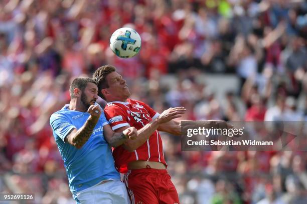 Sascha Moelders of 1860 Muenchen and Nicolas Feldhahn of Bayern Meunchen jump for a header during the Regionalliga Bayern match between FC Bayern...