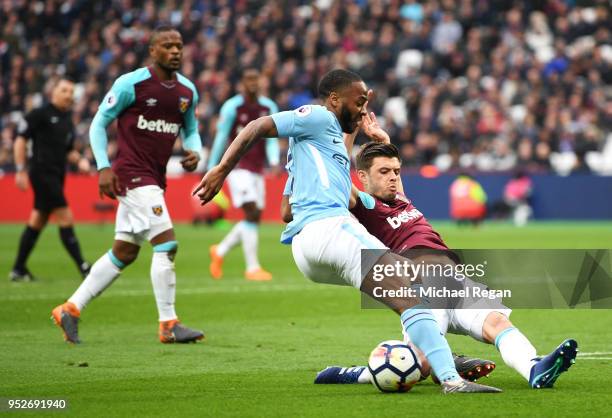 Raheem Sterling of Manchester City is tackled by Aaron Cresswell of West Ham United during the Premier League match between West Ham United and...