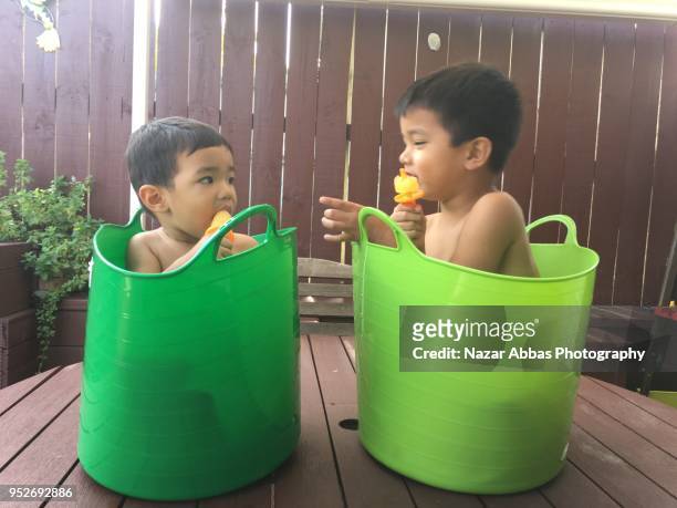 kids having ice block in a hot summer day. - nazar abbas foto e immagini stock
