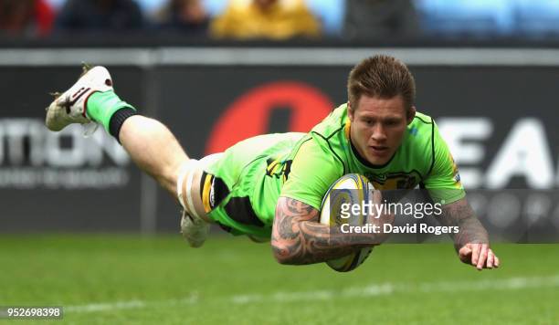Teimana Harrison of Northampton Saints dives to score their first try during the Aviva Premiership match between Wasps and Northampton Saints at The...