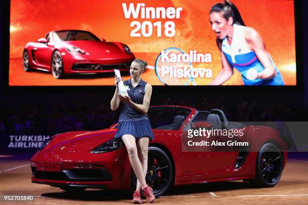 Karolina Pliskova of Czech Republic celebrates with the trophy and the winner's car Porsche 718 Boxster GTS after winning the singles final match...