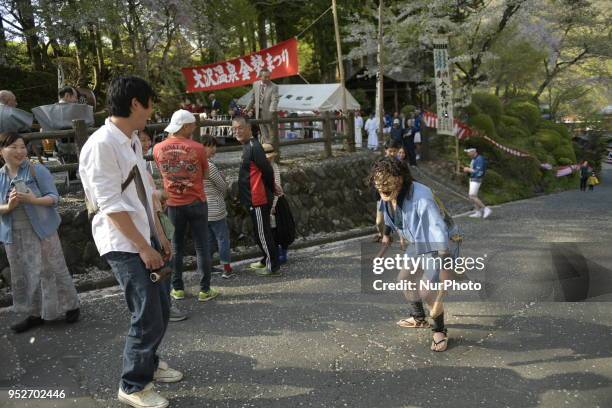 Performer with mask tease festival goer with wooden phallus during the Konsei Festival Fertility Festival at Osawa Onsen in Hanamaki on April 29...