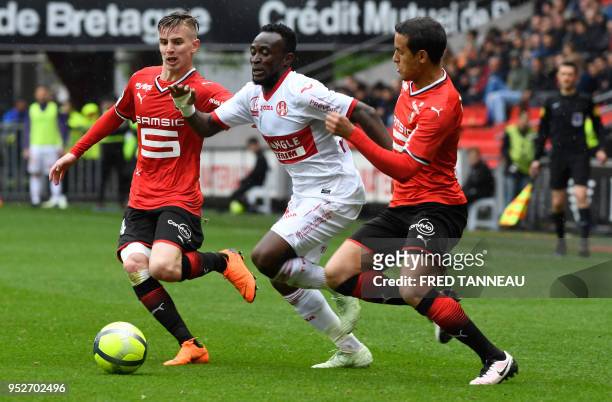 Toulouse's Congolese forward Firmin Mubele Ndombe vies with Rennes' French midfielder Benjamin Bourigeaud and Rennes' Algerian defender Mehdi Zeffane...