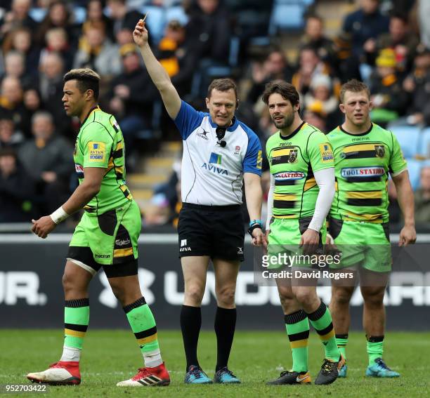 Luther Burrell of Northampton Saints is sent to the sin bin by referee Matthew Carley during the Aviva Premiership match between Wasps and...