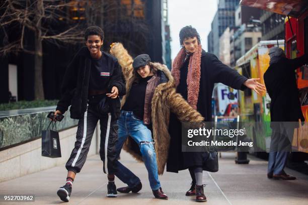 Models Amilna Estevao, Daisy Cvitkovic, Jess Cole on February 12, 2018 in New York City. Amilna wears a black teddy bear coat, black Livincool shirt,...