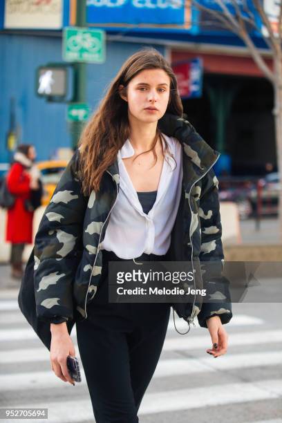 Model Ola Dutka wears a camouflage fleece jacket, white top, and black pants on February 8, 2018 in New York City.