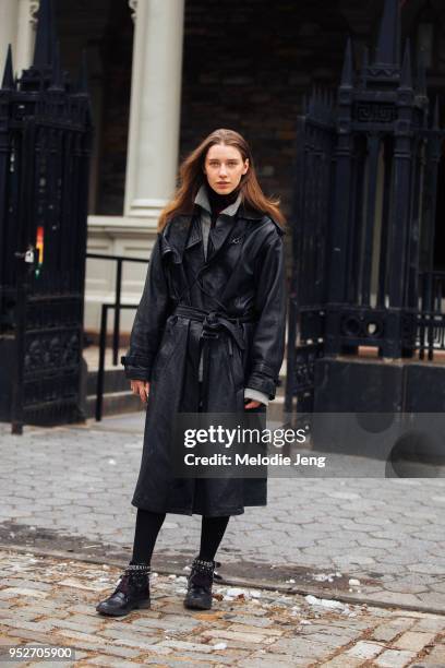 Model Sofia Tesmenitskaya wears a black leather trench coat on February 9, 2018 in New York City.