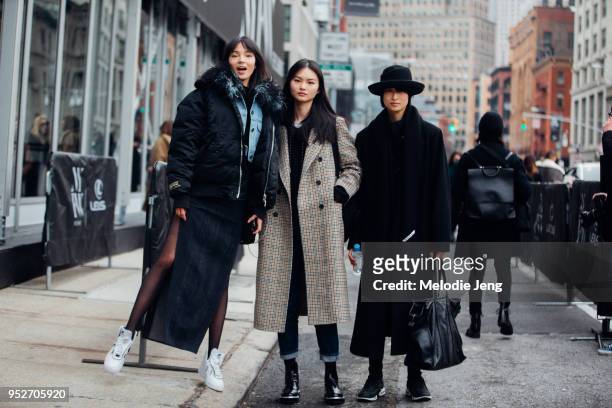 Chinese models Xiao Wen Ju, He Cong, Chu Wong after the Jason Wu show on February 9, 2018 in New York City. Xiao Wen wears a black puffer coat, denim...