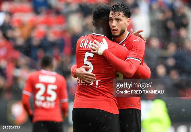 Rennes' Algerian defender Ramy Bensebaini embraces teammate defender Joris Gnagnon after winning the French L1 football match Rennes vs Toulouse on...