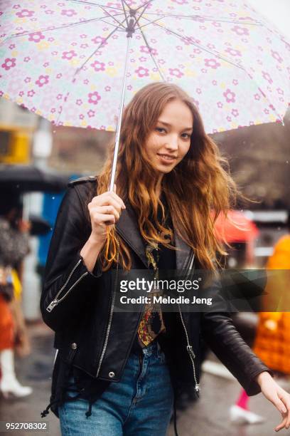 Model Milena Ioanna wears a black leather jacket and pink floral umbrella on February 11, 2018 in New York City.