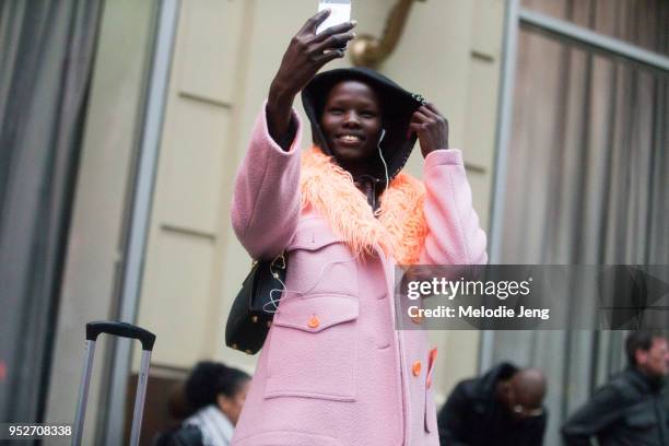 Model Shanelle Nyasiase takes a selfie and wears a black hood and pink coat with an orange fur lining after the Sie Marjan show on February 11, 2018...
