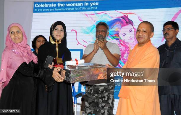 Uttar Pradesh Chief Minister Yogi Adityanath giving away HT Women Award to Dr Roshan Jahan Jawad Ahmed Shaikh in Lucknow, India, on April 29, 2018....