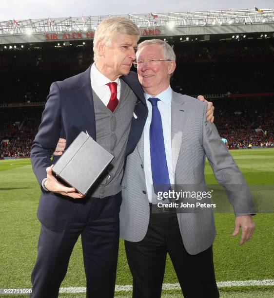 Former manager Sir Alex Ferguson of Manchester United presents Manager Arsene Wenger of Arsenal with a gift to mark his retirement ahead of the...