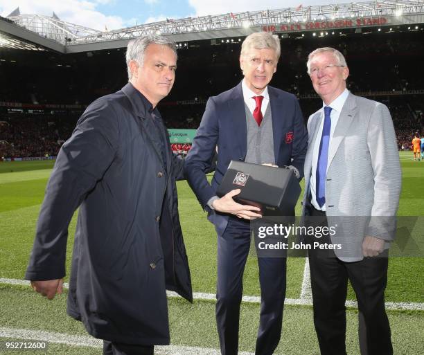 Manager Jose Mourinho and Former manager Sir Alex Ferguson of Manchester United present Manager Arsene Wenger of Arsenal with a gift to mark his...