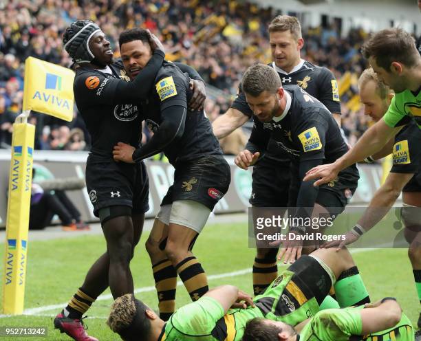 Juan de Jongh of Wasps is congratulated by team mate Christian Wade after scoring a try during the Aviva Premiership match between Wasps and...