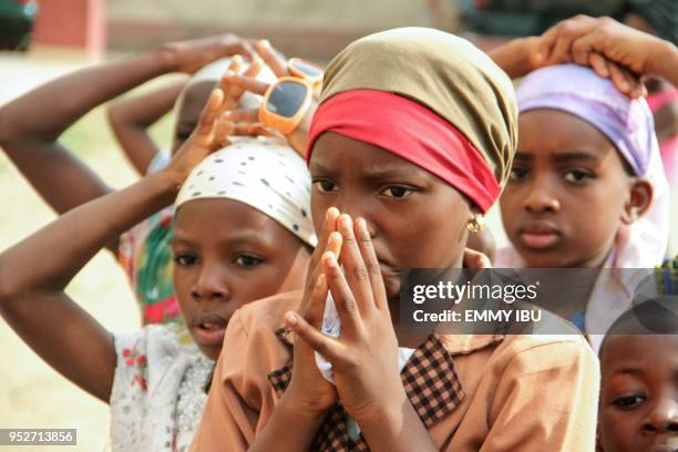 Children pray during as Christian community members take part in a protest against the killing of people by suspected herdsmen in Makurdi,...