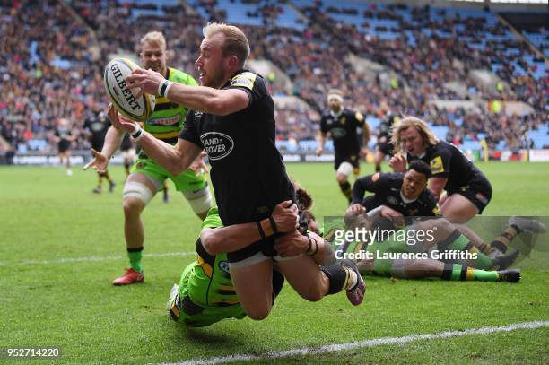 Dan Robson of Wasps is tackled by Piers Francis of Northampton Saints during the Aviva Premiership match between Wasps and Northampton Saints at The...