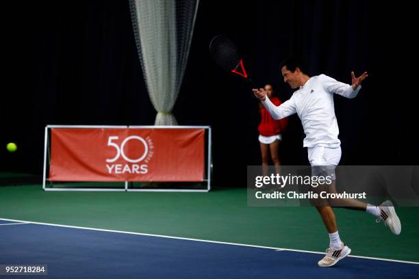 Tim Henman in action during The Lawn Tennis Association celebratory 50 years of Open Era tennis at the West Hants Club in Bournemouth, back where the...