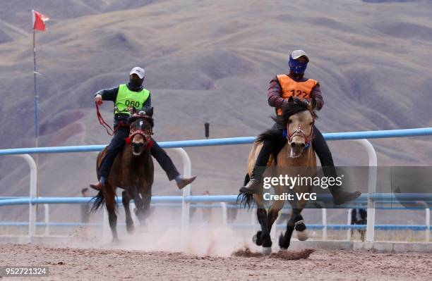 Horse riders show their equestrian skills during a horse racing festival on April 29, 2018 in Zhangye, Gansu Province of China. Over 200 horse riders...