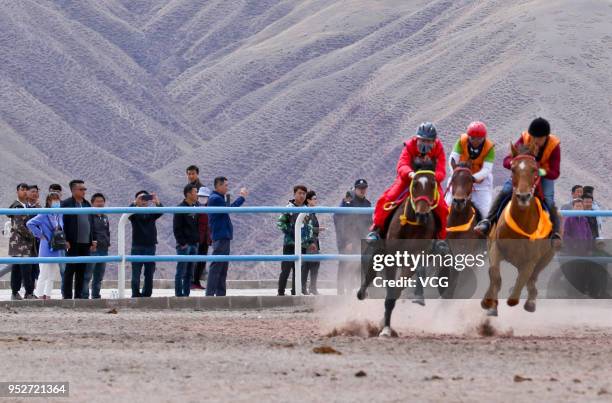 Horse riders show their equestrian skills during a horse racing festival on April 29, 2018 in Zhangye, Gansu Province of China. Over 200 horse riders...