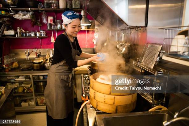 women chef preparing food - chef apron stock pictures, royalty-free photos & images