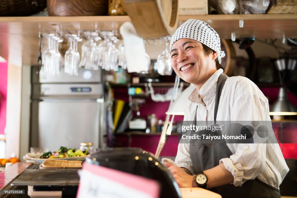 Japanese woman chef who shows a smile in the kitchen