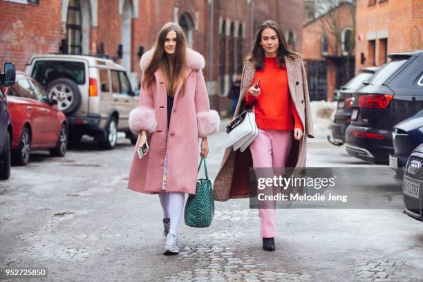 Guest wears a pink peacoat with fur collars an cufs with a green Goyard bag, white stockings, and white New Balance shoes. A guest wears a checkered...