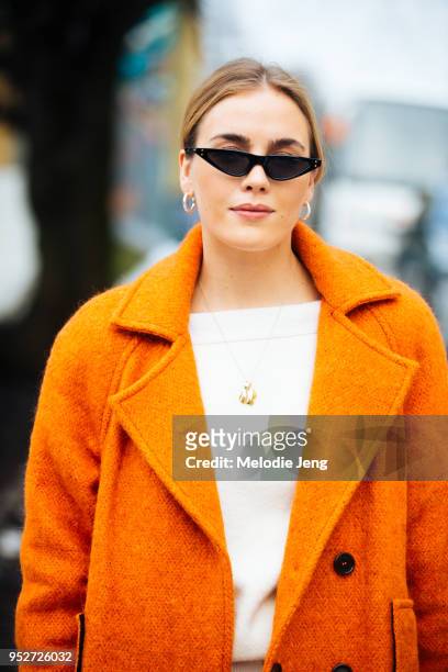 Guri Heli wears an orange Iben coat on January 26, 2018 in Oslo, Norway.