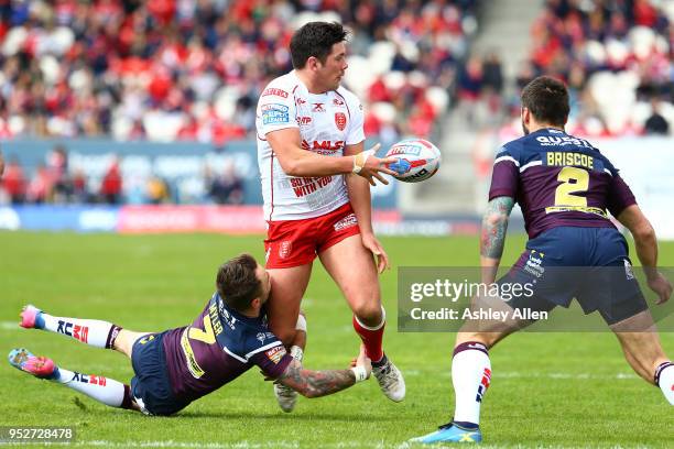 Chris Clarkson of Hull KR passes the ball to a team mate as Richie Myler of Leeds Rhinos tackles him during the BetFred Super League match between...