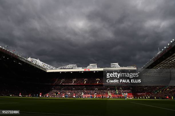 Dark clouds hang over Old Trafford during the English Premier League football match between Manchester United and Arsenal at Old Trafford in...