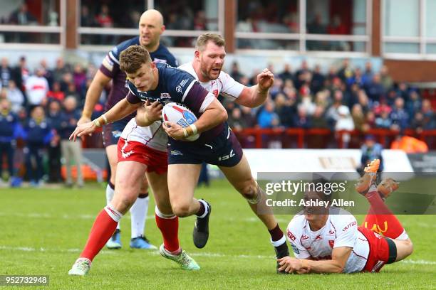 Ash Handley of Leeds Rhinos is challenged by Danny McGuire and Danny Tickle during the BetFred Super League match between Hull KR and Leeds Rhinos at...